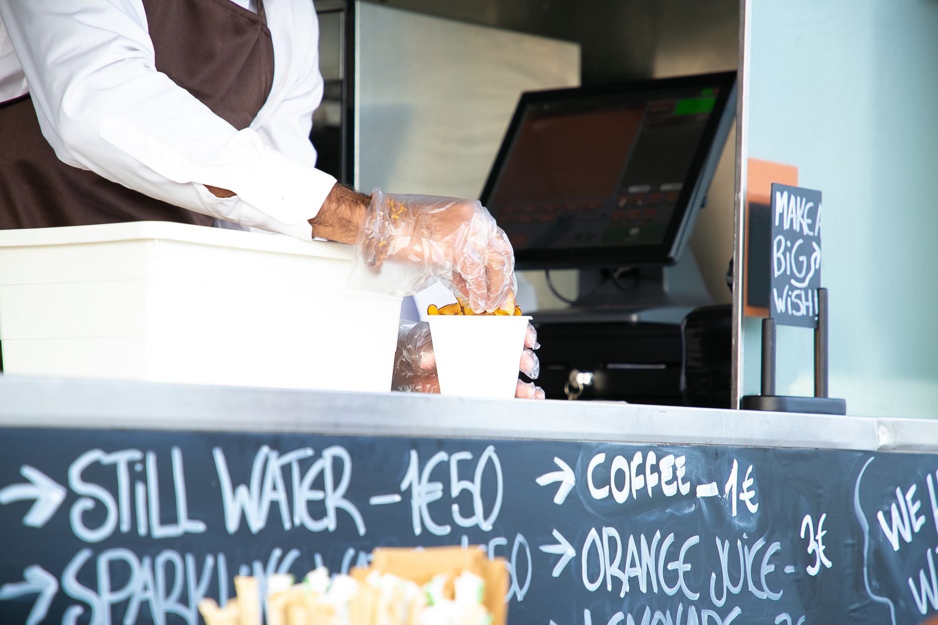 Person using a payment terminal at a food counter