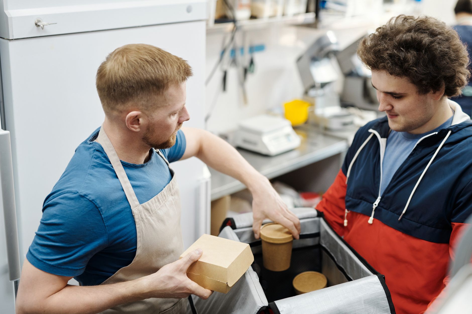 Two people handling a takeaway food order